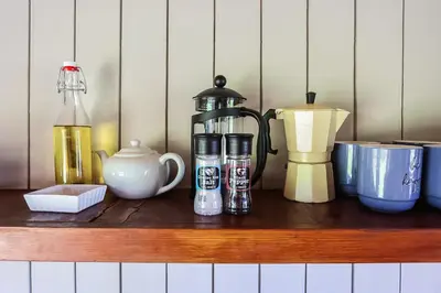 a shelf with a coffee maker and other items on it at Galileo Farm in Elgin