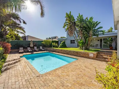 a swimming pool in the backyard of a house at Hajo's Lodge & Spa in Cape Town