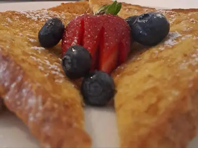 a piece of toast with fruit on top of it at Hajo's Lodge & Spa in Cape Town