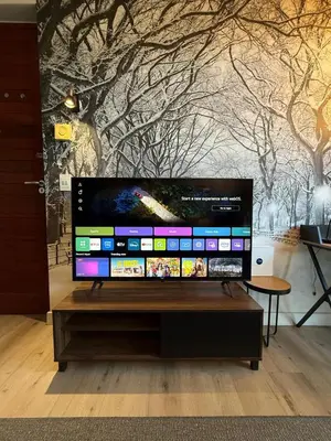 a flat screen tv sitting on top of a wooden table at CAG Bosman's Crossing Stellenbosch in Stellenbosch