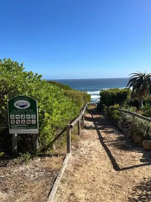 a sign on a path to the beach at Vermont Hermanus Flatlet in Hermanus