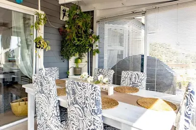 a dining room with a table and chairs at Upper Dunes Apartment in Pringle Bay