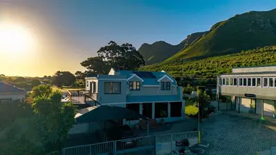 an aerial view of a house with mountains in the background at Onrus Family Retreat in Hermanus