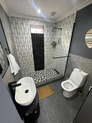 a bathroom with a toilet and a sink and a shower at Studio Seabiscuit in Cape Town