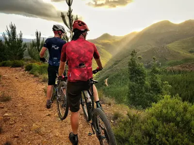 two people riding bikes on a dirt trail at Swannie Creek in Grabouw