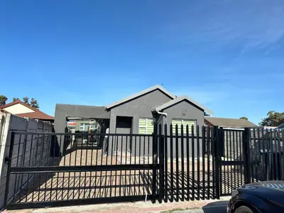 a black fence in front of a house at 29 on Windsor-2 Bedroom House in Silver Sands