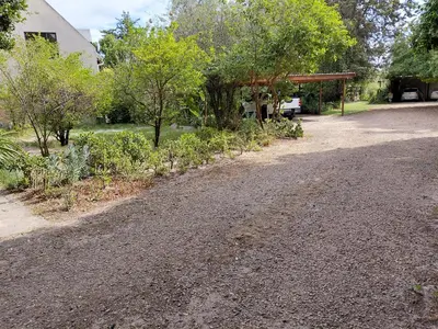a gravel driveway with trees and a pavilion at Place of Old D in Eersterivier