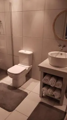 a bathroom with a toilet and a sink at 6 on Krisant-Durbanville in Oakdale
