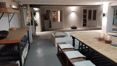 a living room with a table and chairs in a room at 6 on Krisant-Durbanville in Oakdale