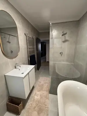 a bathroom with a sink and a tub and a mirror at 4 Molteno in Hermanus