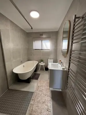 a bathroom with a bath tub and a sink at 4 Molteno in Hermanus