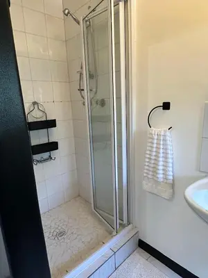 a bathroom with a shower and a sink at A Stone's Throw away in Cape Town