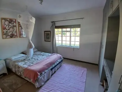 a bedroom with a bed and a window at Spacious Family Home - Windsor Retreats in Somerset West