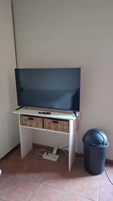 a flat screen tv on a white table at MDA Myburgh in Brackenfell