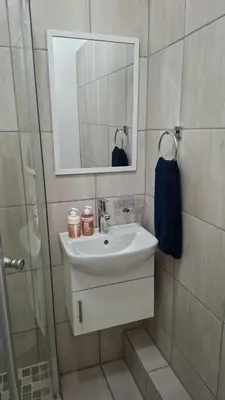 a bathroom with a sink and a mirror at MDA Myburgh in Brackenfell