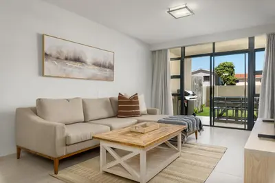 a living room with a couch and a table at La Cabina 105 in Cape Town