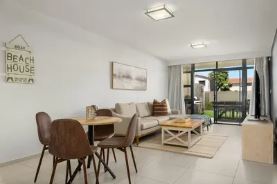 a living room with a couch and a table at La Cabina 105 in Cape Town