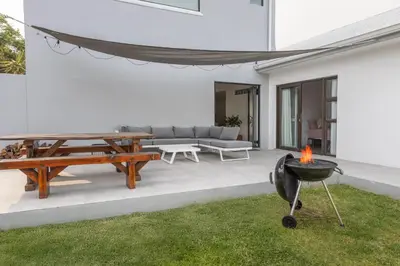 a patio with a grill and a picnic table at 5 Bedroom Family Home with Private Apartment in Hermanus