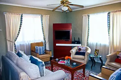 a living room with two couches and a table at Fijnbos - Something-Els in Rooiels