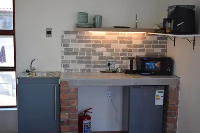 a kitchen with a counter and a brick wall at The Crest Studio in Oakdale