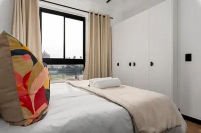 a bedroom with a bed with a pillow and a window at Nine Palms Stunning 1-Bedroom Apartment in Century City