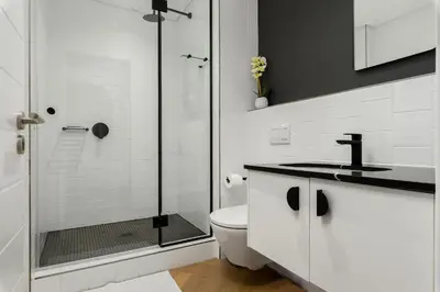 a bathroom with a shower and a toilet and a sink at Nine Palms Stunning 1-Bedroom Apartment in Century City