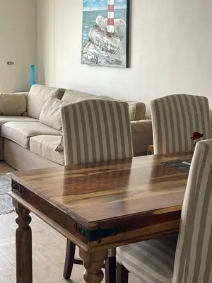 a living room with a wooden table and a couch at 510 Odeon Towers - SeaView in Strand