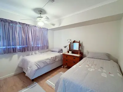 a bedroom with two beds and a television in it at 510 Odeon Towers - SeaView in Strand