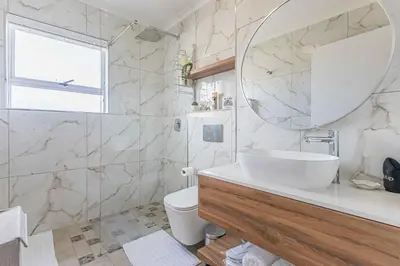 a bathroom with a sink and a mirror at Bella View in Cape Town