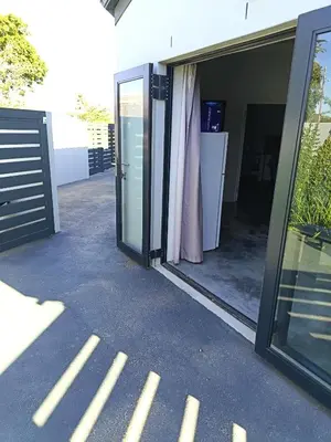 an open glass door of a building with a patio at 66onjennings Strand in Strand