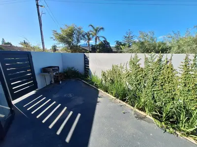 a fence with a gate in front of a yard at 66onjennings Strand in Strand