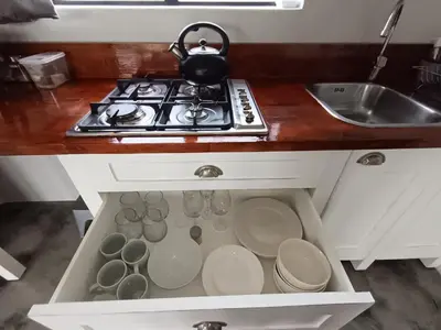 a kitchen counter with a stove and some dishes at 66onjennings Strand in Strand