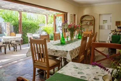 a dining room with a table and chairs at 5 Seasons Guest House in Stellenbosch