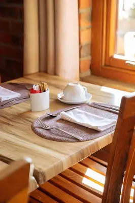 a wooden table with a plate of food on it at Lovane Boutique Wine Estate and Guesthouse in Stellenbosch