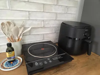 a counter with a toaster and a coffee maker at Swallows Nest Garden Cottage in Helderberg