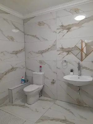 a bathroom with a toilet and a sink at Livingsound 1bed self cat apartment in Cape Town