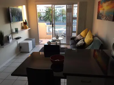 a living room with a couch and a table at 10 South Views in Bloubergstrand