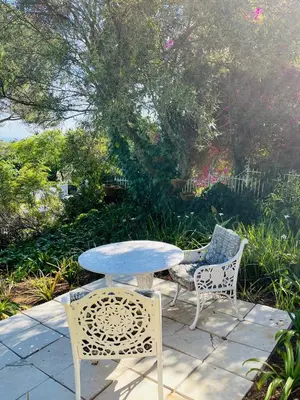 a table and two chairs sitting on a patio at 41 on RUPERT in Helderberg