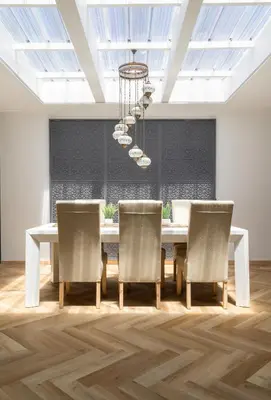 a dining room with a table and chairs and a chandelier at Villa Noor Modern 2 Bed Luxury Retreat in Hanover Park