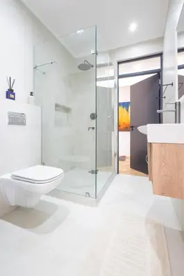 a bathroom with a toilet and a sink and a shower at Villa Noor Modern 2 Bed Luxury Retreat in Hanover Park