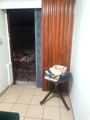 a table with books on it next to a door at Central, Spacious GF Apartment, access to N1,N2,M5