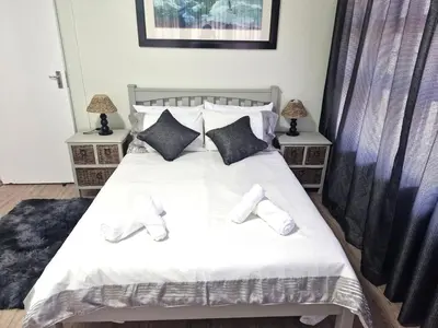 a bedroom with a bed with white shoes on it at Central, Spacious GF Apartment, access to N1,N2,M5