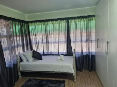 a bedroom with a bed with curtains and a window at Central, Spacious GF Apartment, access to N1,N2,M5