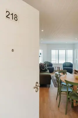 a living room with a table and a couch at Hermanus Beach Club 218 in Hermanus