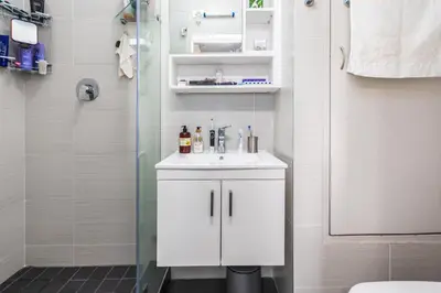a bathroom with a white sink and a shower at Family Oasis with Pool close to Shopping Center in Cape Town