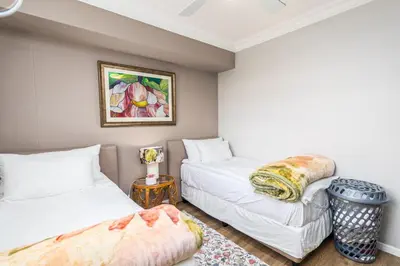 a bedroom with two beds and a table at Family Oasis with Pool close to Shopping Center in Cape Town