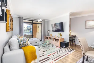 a living room with a white couch and a glass table at Family Oasis with Pool close to Shopping Center in Cape Town