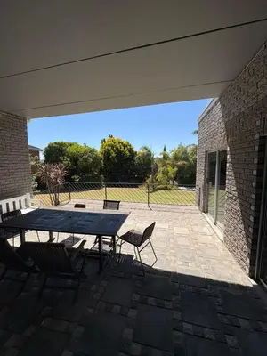a patio with a table and chairs and a brick wall at North of the vines in Oakdale