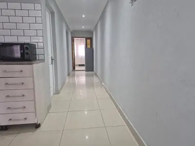 an empty hallway with a kitchen and a microwave at Maglovir economy 3 BEDROOMS BULK in Tiervlei