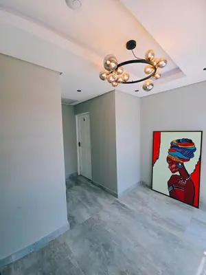 a room with a painting on the wall and a chandelier at Beach Walk Guest House & Apartments in Cape Town